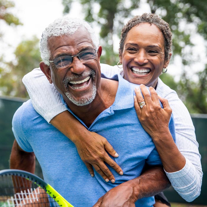 couple hugging after playing tennis