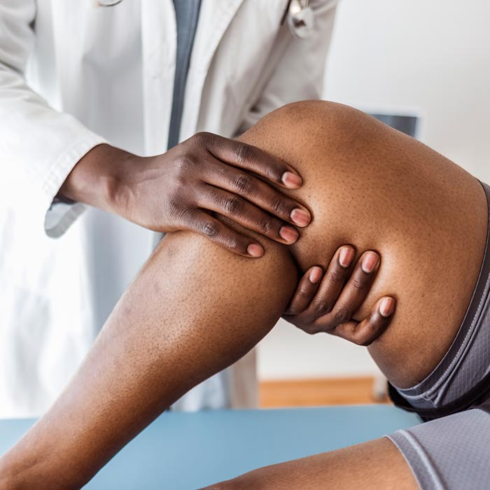 doctor touching patient's knee