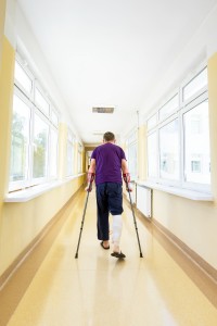 man walks on crutches