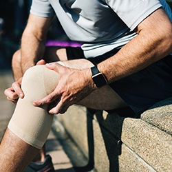 Man holding his knee in pain