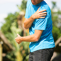 Man holding his shoulder in pain