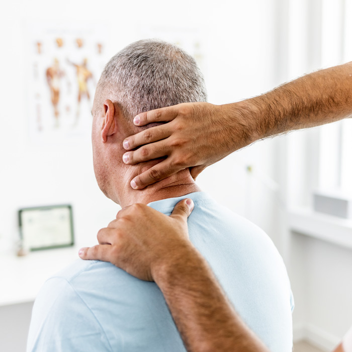 doctor examining patient's neck